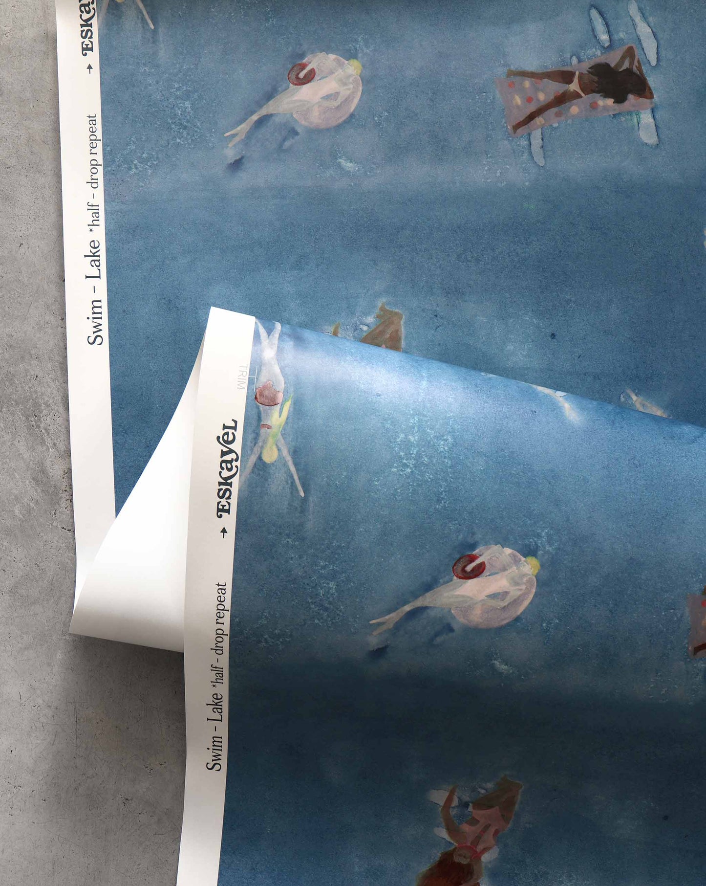 A closeup image of Swim Lake Wallpaper with its navy blue background and waterborne female figures throughout.