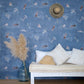 Eskayel's Swim wallpaper in the colorway Lake in navy blue with waterborne female figures installed in a room.