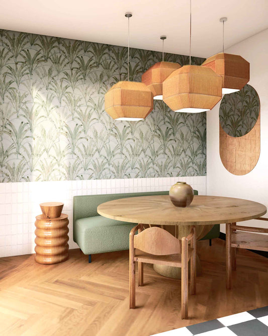 A dining room with a Travelers Palm Wallpaper Sage table