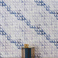 A blue and white luxury geometric wallpaper in a room featuring the Triangle Checks Wallpaper Ocean collection from a geometric sequence