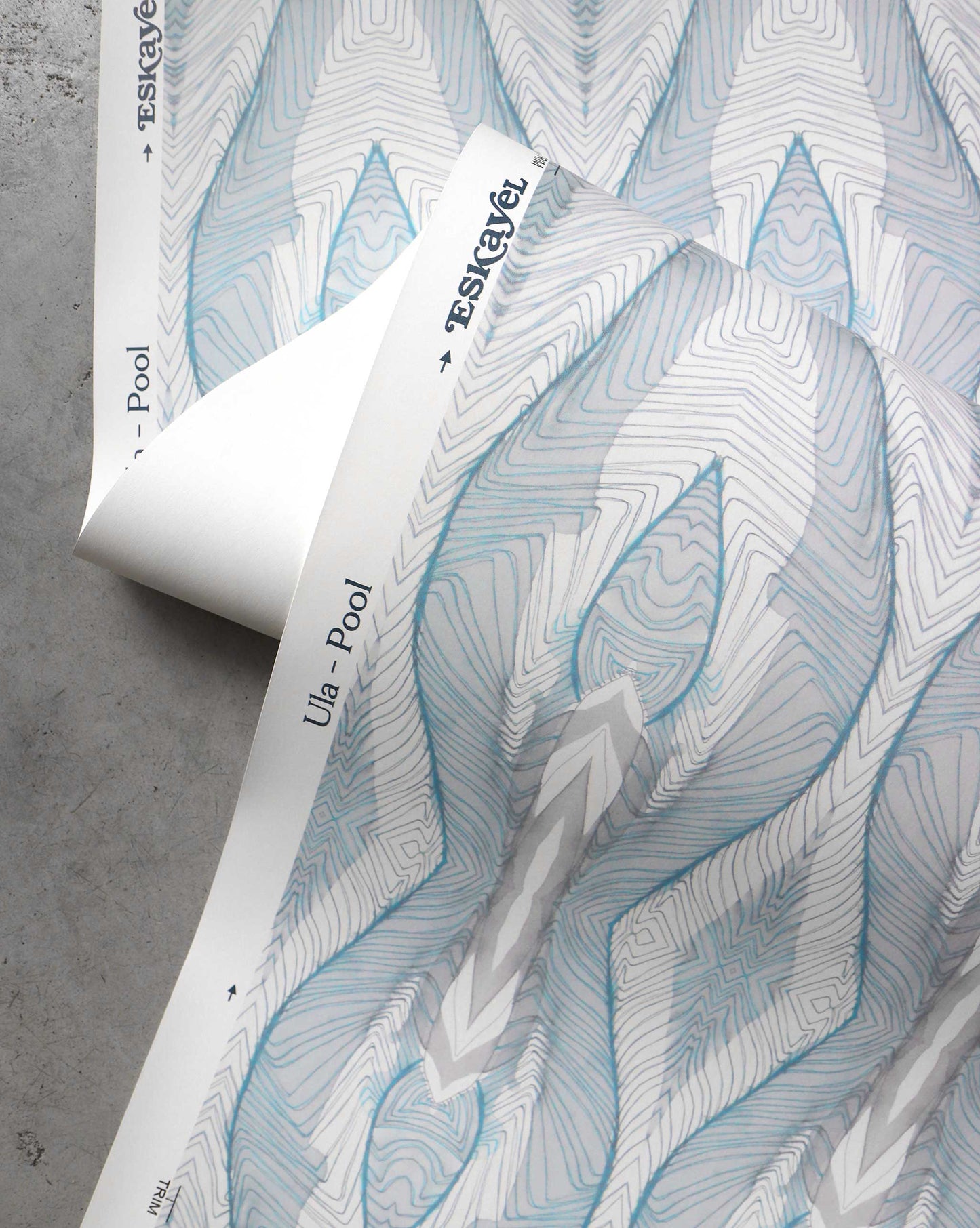 A detail shot of Eskayel's Ula Wallpaper in the colorway Pool with a teal,white, and grey design.