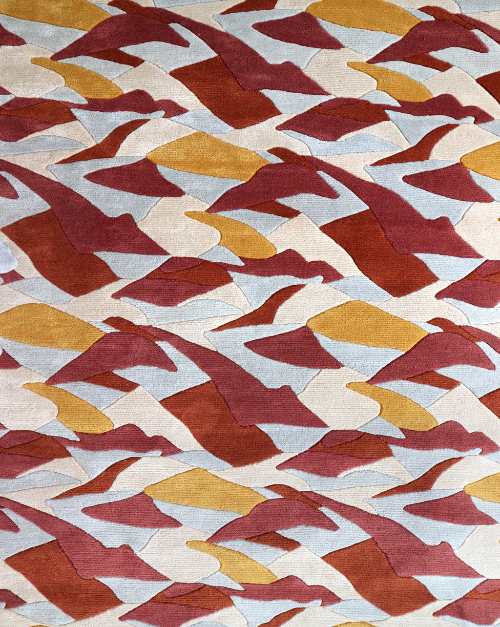 A sumptuous Mani Hand Knotted Rug 5' x 8' Fire with a red, yellow, and blue pattern