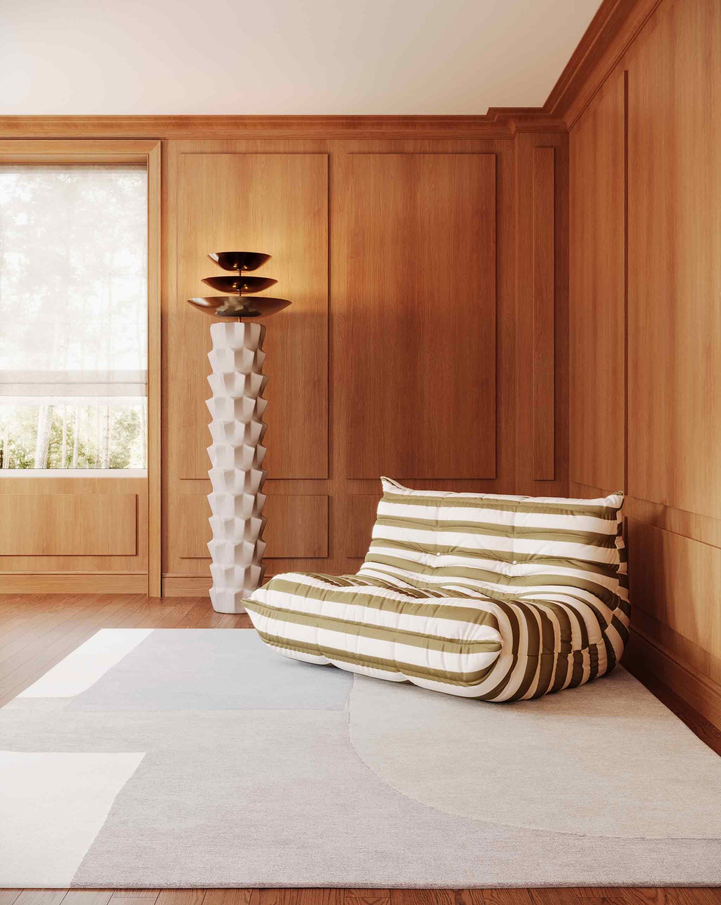 The Blocked rug in Cloud with its neutral matte colorway installed in a living room with a striped couch and a floor lamp.