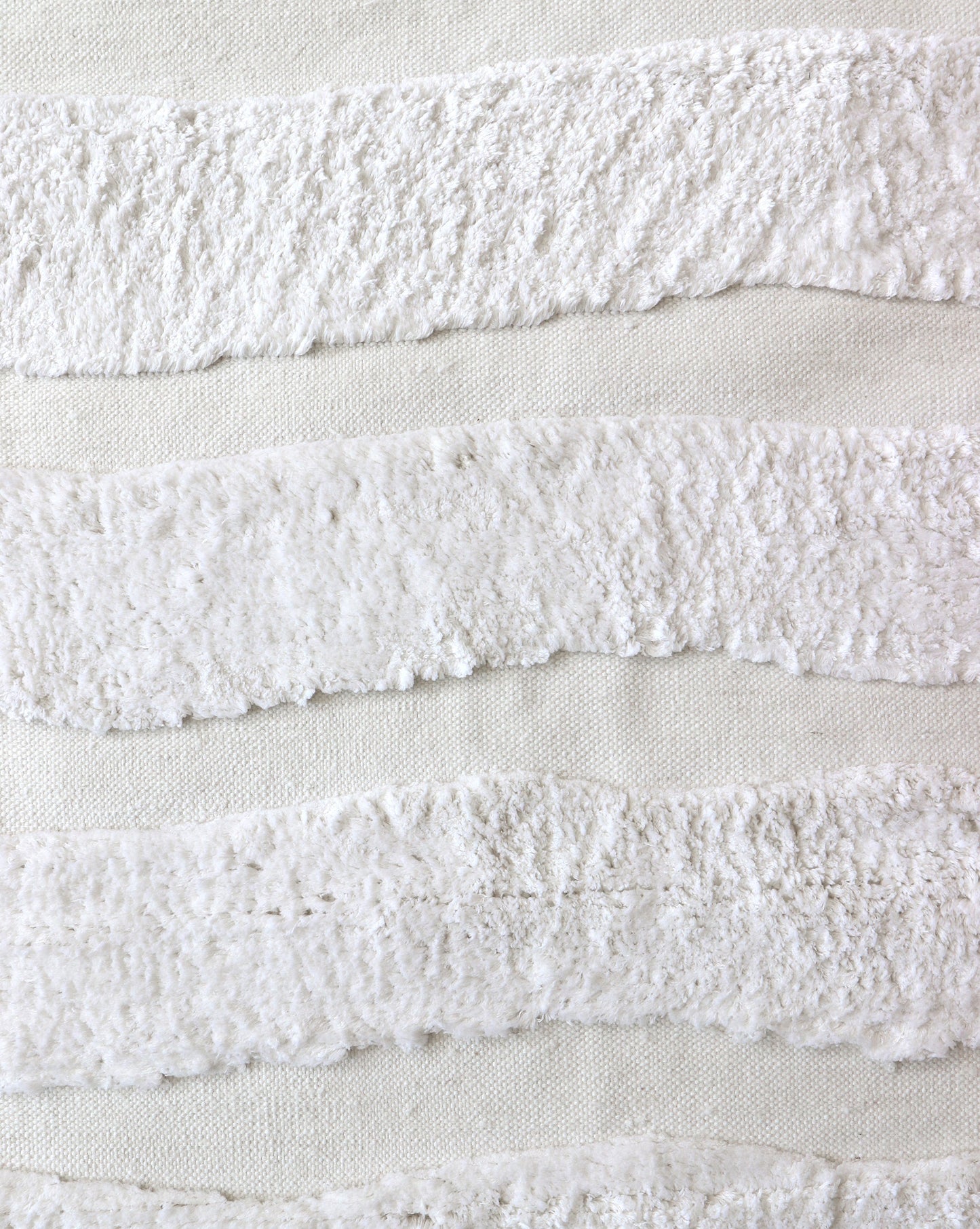 A close up of a Bold Stripe Hand Knotted Rug 6' x 9' Lefko White on a white piece of fabric