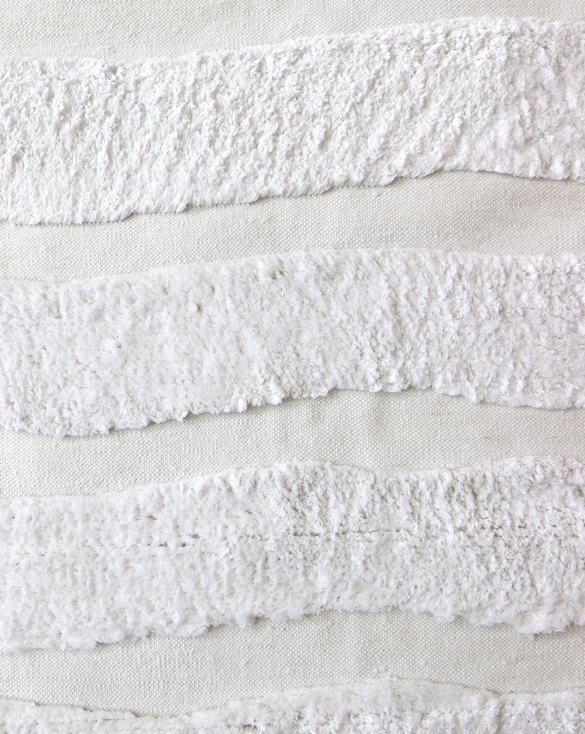 A close up of a Bold Stripe Hand Knotted Rug 6' x 9' Lefko White on a white piece of fabric