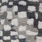 A close up of a grey and white 100% wool Chess Hand Knotted Rug 5' x 8'   Greyscale