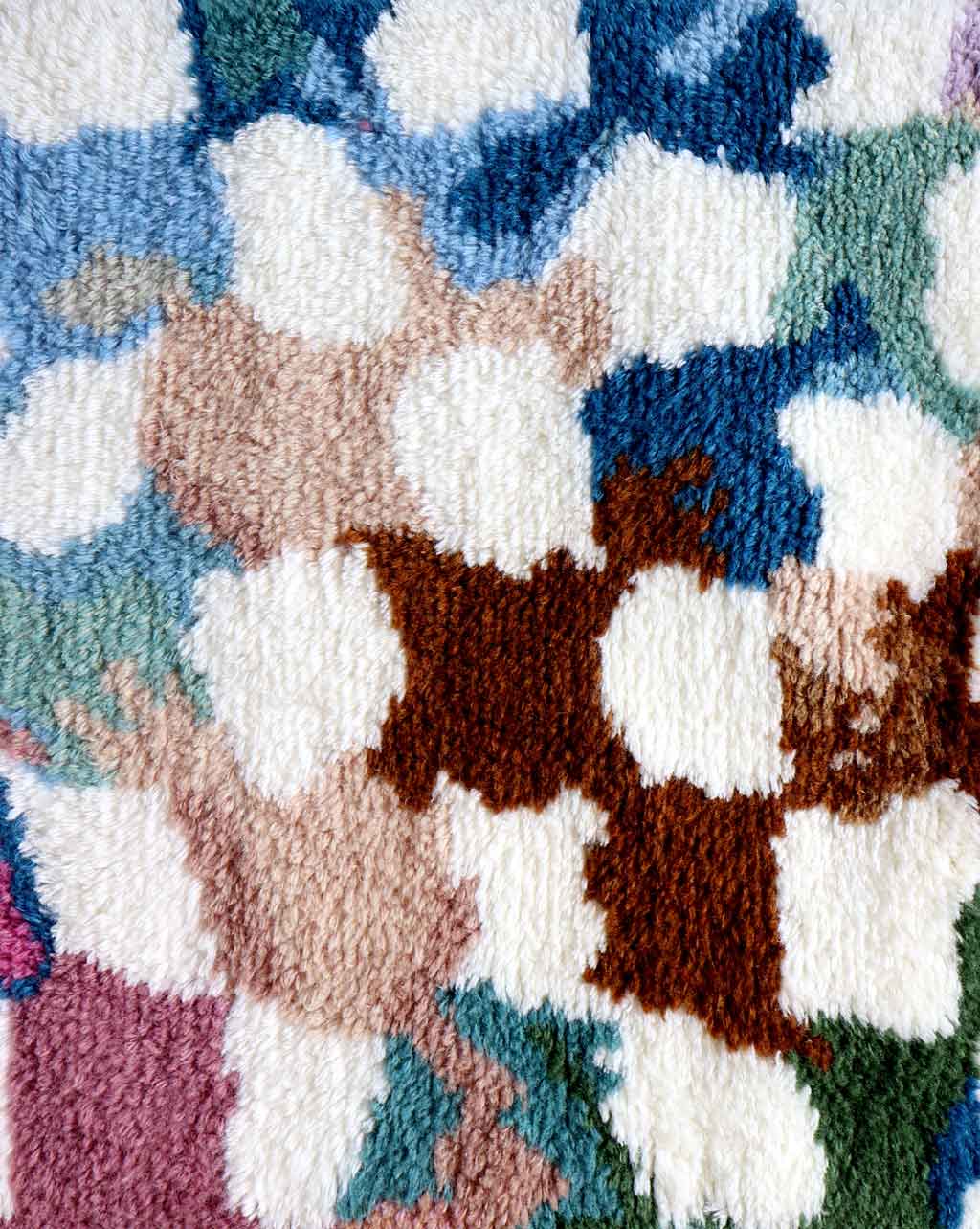 A close up of a Chess Hand Knotted Rug Multi with a checkered pattern