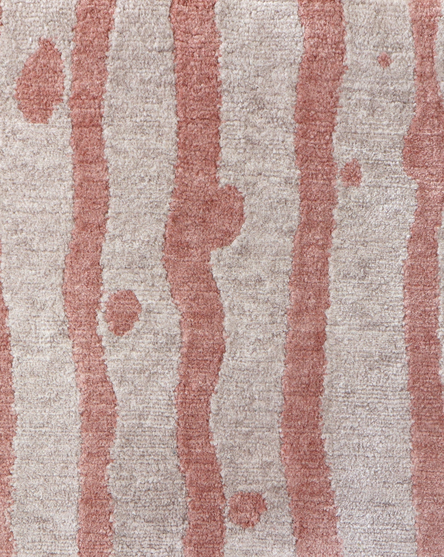 A Drippy Stripe Hand Knotted Rug 6' x 9' Sienna with rosy pink stripes on it