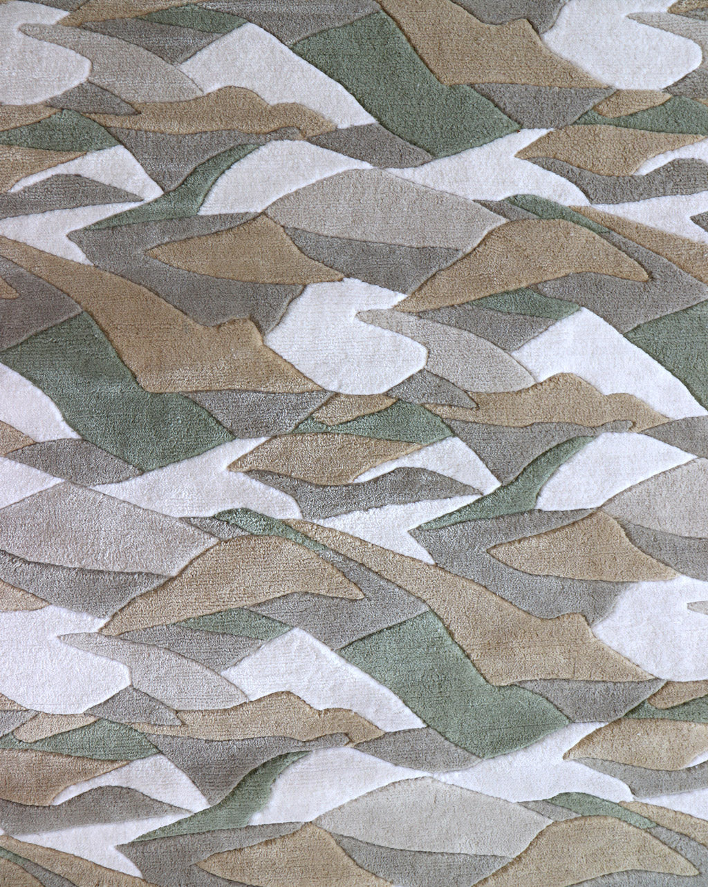 A sumptuous merino wool Mani Hand Knotted Rug 5' x8' Earth with a camouflage pattern and hand-cut bevels on the fabric