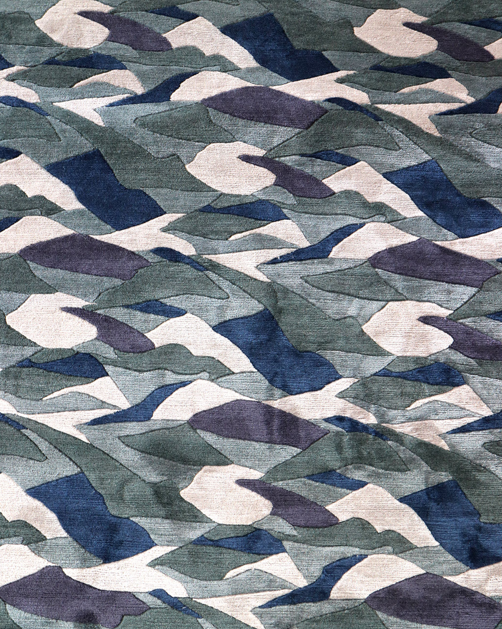 A green and blue fabric with a Mani Hand Knotted Rug Water pattern in different colorways
