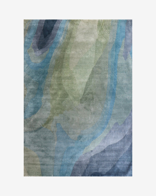 A Progressions Hand Knotted Rug 5' x 8' in the Thalassa colorway, showcasing the chromatic beauty of nature with a wave pattern