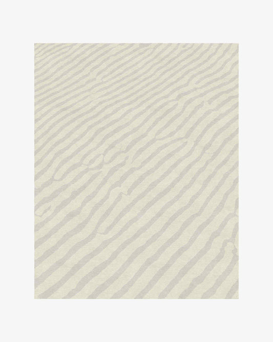 Made of soft merino wool, Eskayel’s Sand Lines rug in Sand is a colorway of beige and grey.