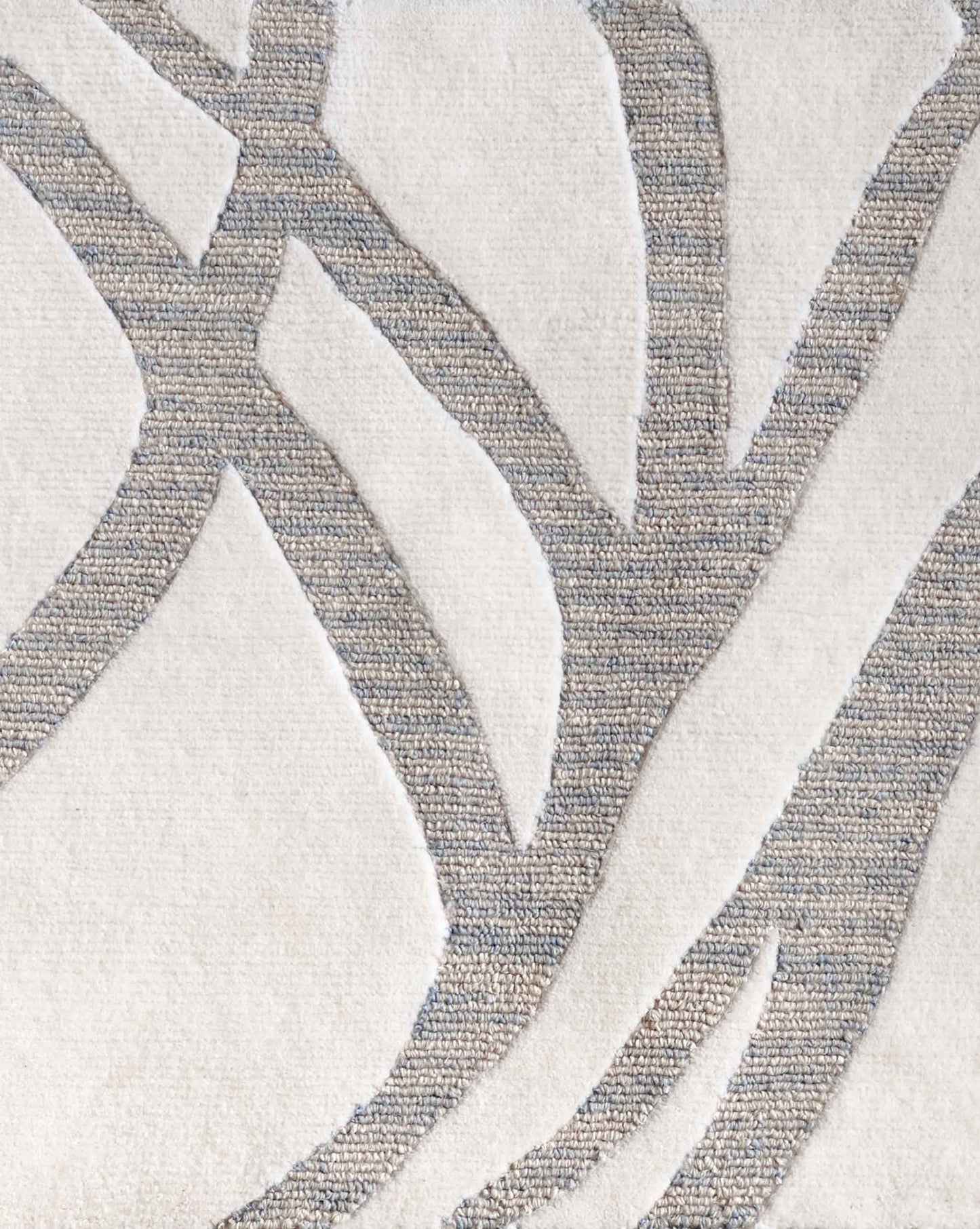 A swatch of Eskayel’s Hibiscus Lily rug in Cloud displays a colorway of white, cream and blue shades.