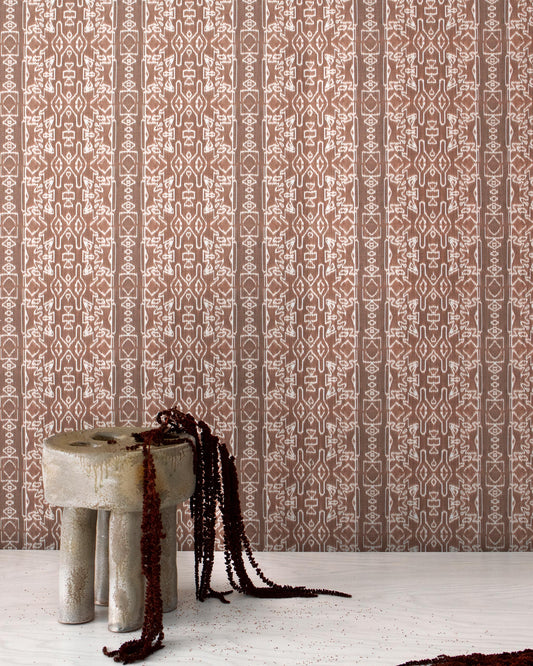 A brown and white Akimbo Grasscloth Morinda Ikat design with a stool in front of it