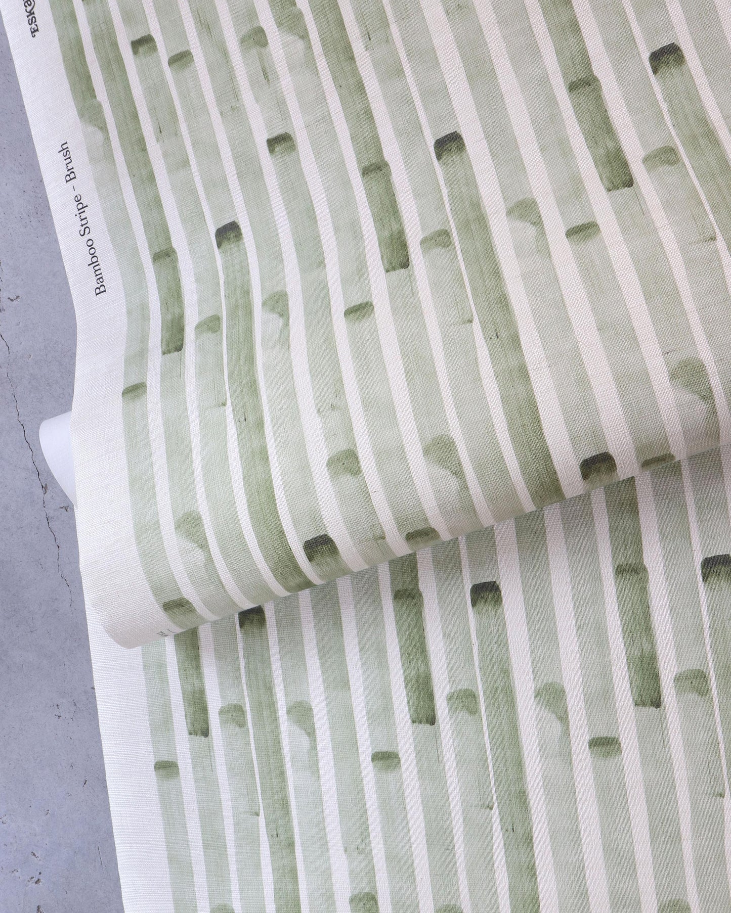 A green and white striped Bamboo Stripe Grasscloth Brush wallcovering