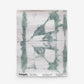 A green and white Banda Grasscloth Chloros tie-dye pattern on a piece of wallpaper