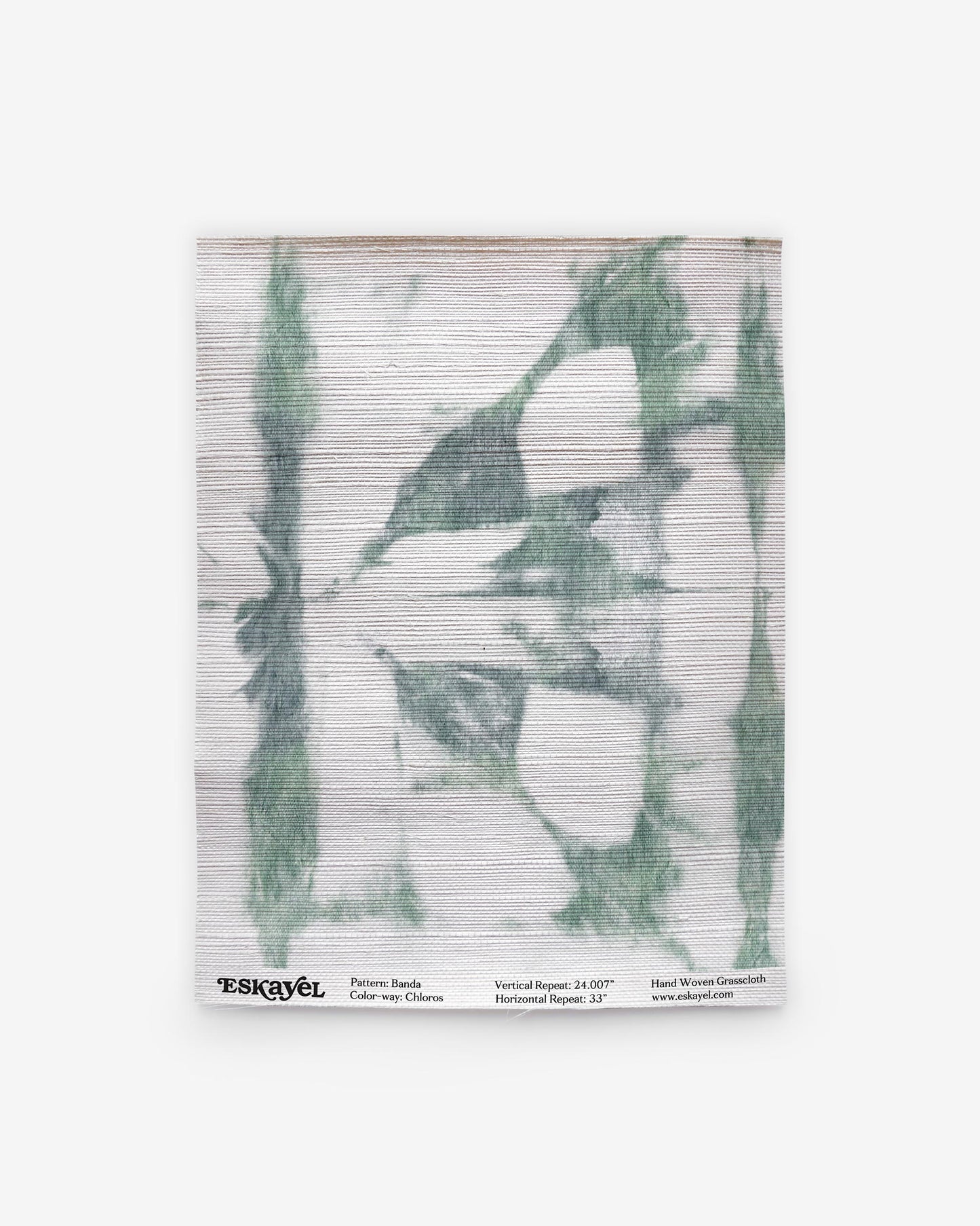 A green and white Banda Grasscloth Chloros tie-dye pattern on a piece of wallpaper