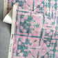 A Banda Grasscloth Pinken fabric by Eskayel on a table