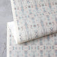 A piece of wallpaper with a blue and white Biami Grasscloth Hide pattern on it