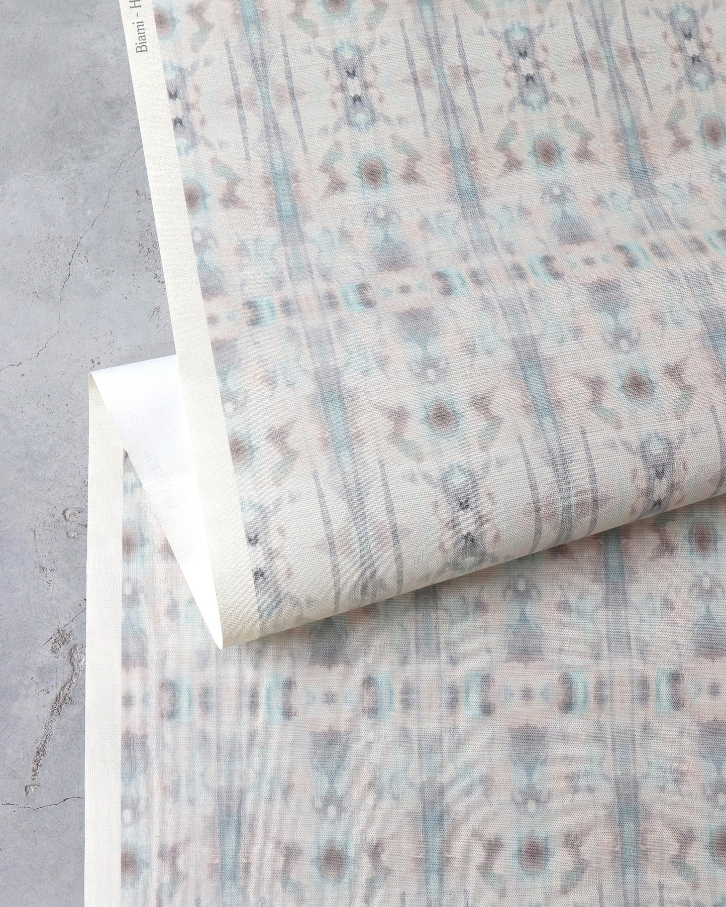 A piece of wallpaper with a blue and white Biami Grasscloth Hide pattern on it