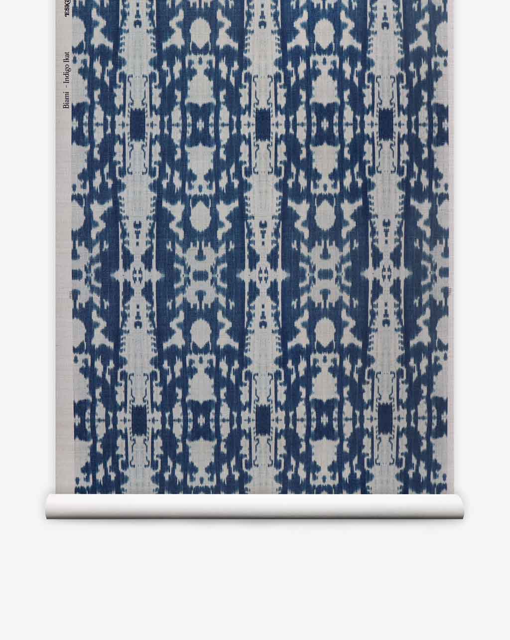 A blue and white Biami Grasscloth Indigo ikat on wallpaper