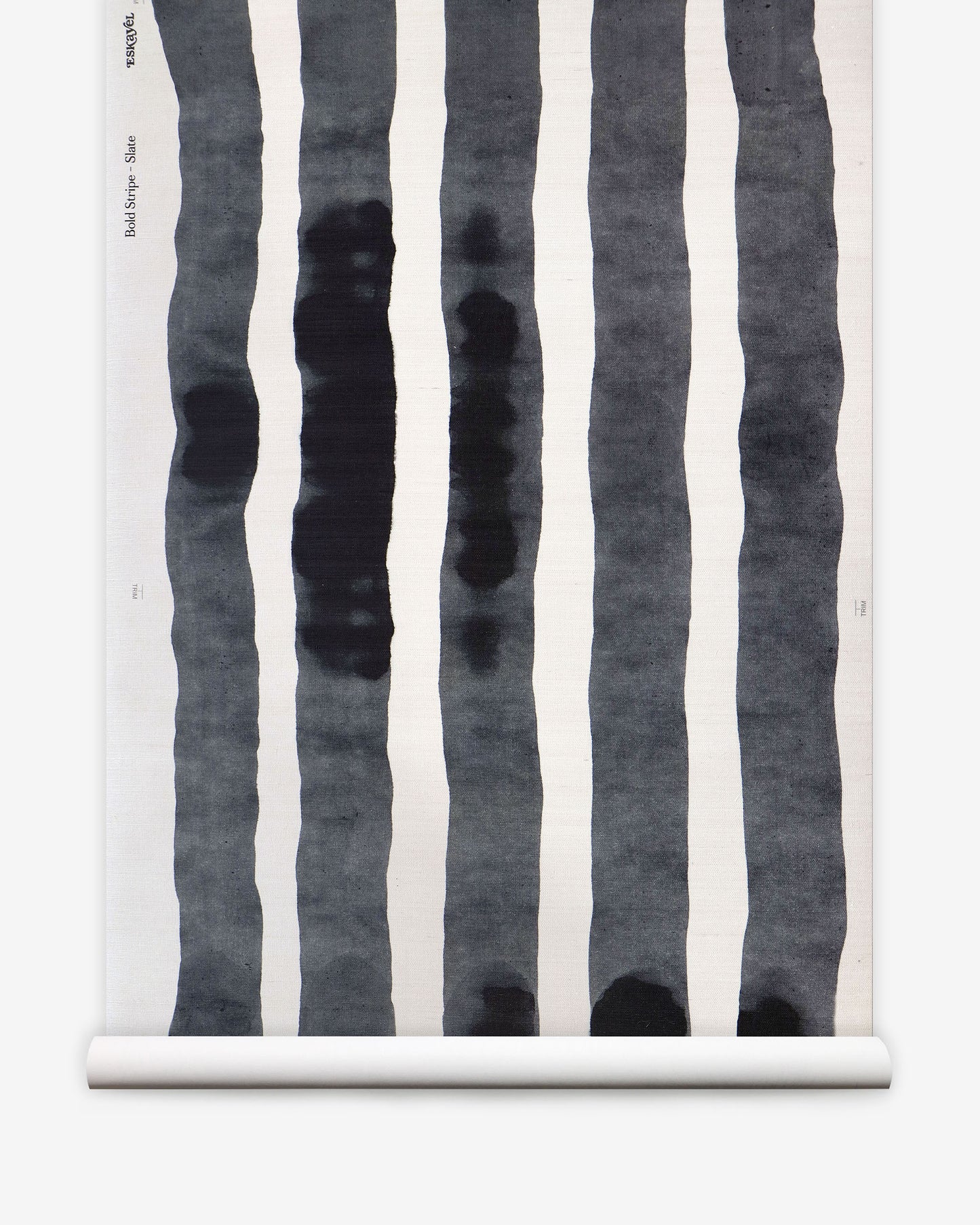 A roll of Bold Stripe Grasscloth Slate from Eskayel's Stripes Collection