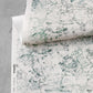 A piece of Bosky Toile Grasscloth Chloros with a green and white pattern on it