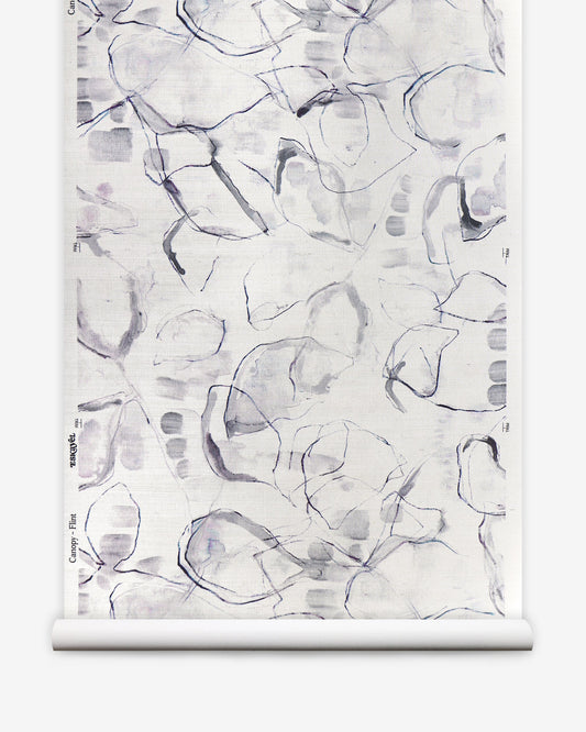 A roll of Canopy Grasscloth Flint wallpaper with a grey and white pattern on it