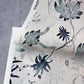 A floral chinoiserie-inspired pattern on an Edera Grasscloth Ice piece of paper in collaboration with Eskayel