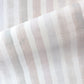 A close up image of a Gradient Stripe Grasscloth Pink Island fabric in gradient stripe colorways