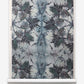 A roll of Laurel Forest Grasscloth Thicket wallpaper with a blue and white floral pattern