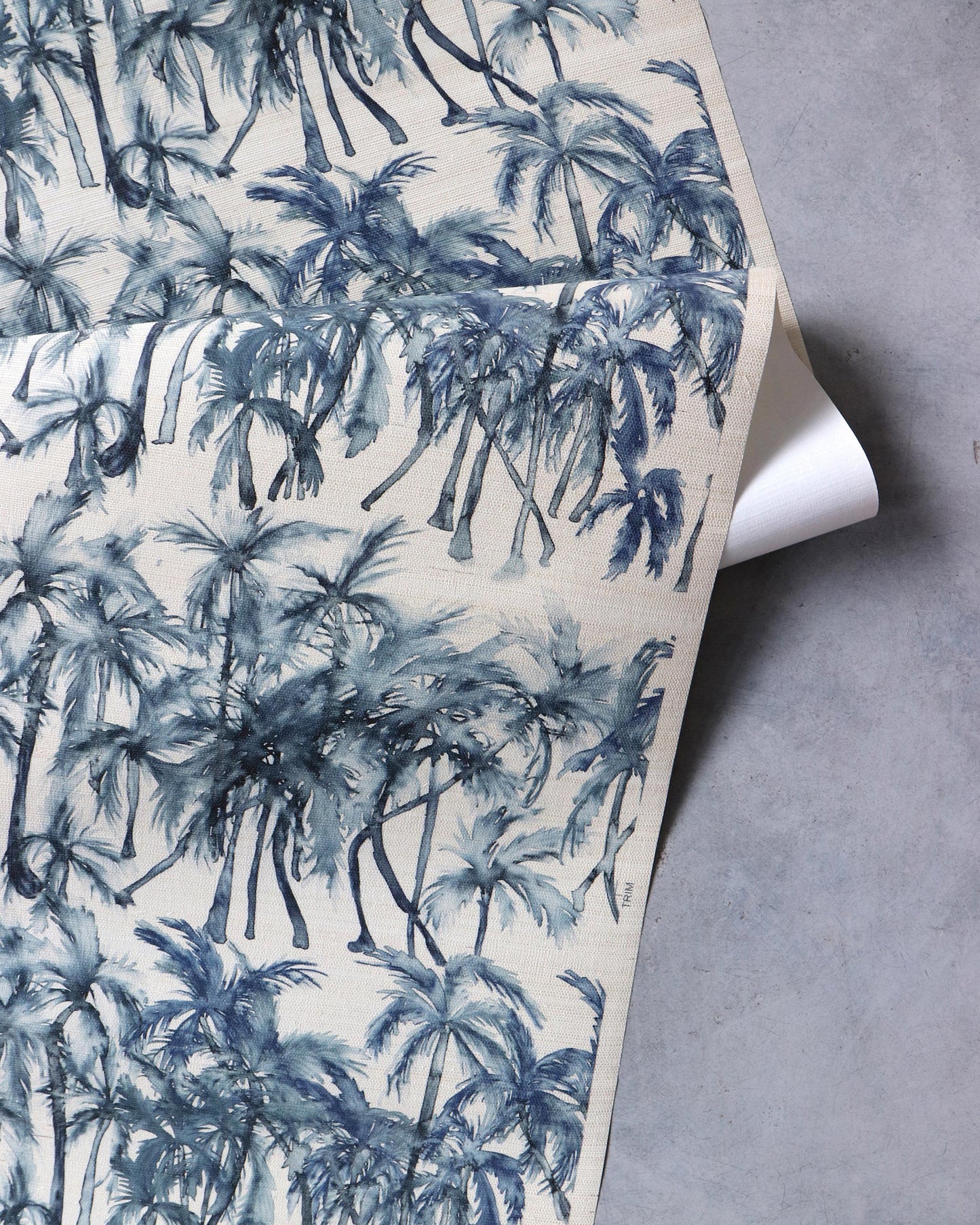 A blue and white Palm Dance Grasscloth||Midnight with palm trees on it.