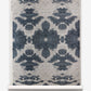 A roll of wallpaper with a blue and white design from The Dance Grasscloth Olive Collection