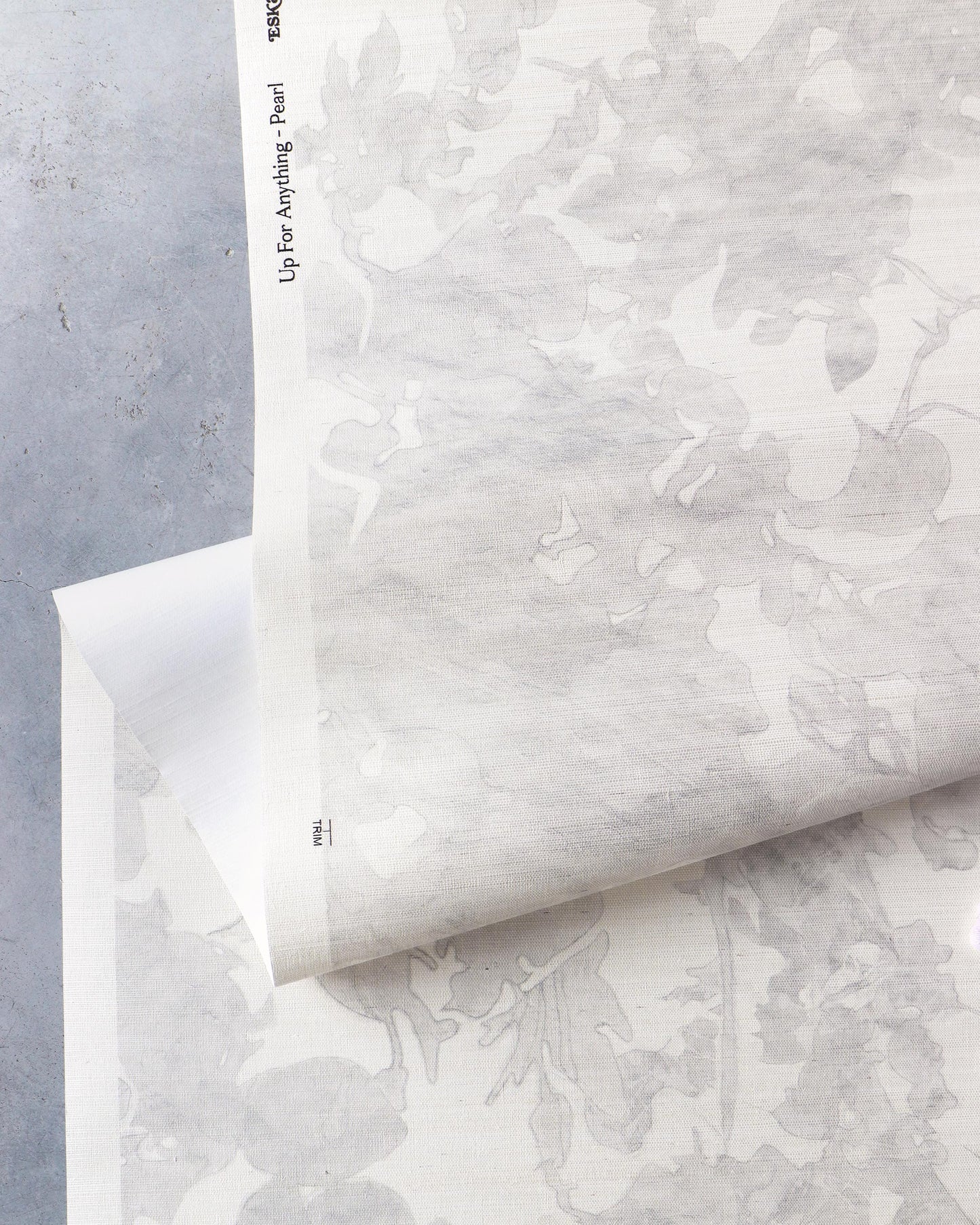 A luxurious Up for Anything Grasscloth Pearl wallcovering with an abstract botanical pattern on it