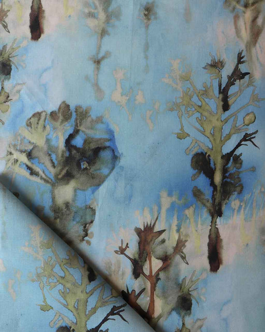 A blue Aionas Fabric with trees on it, perfect for wallpaper or fabric decorations