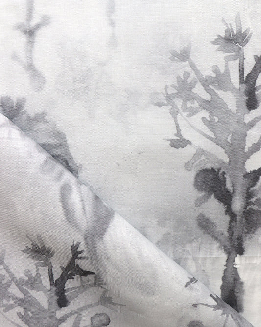 A high-end Aionas Fabric Phyllite wallpaper featuring a close up of a black and white fabric with flowers on it