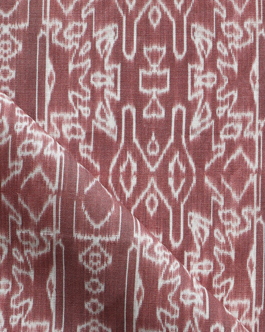 A close up of a red and white Akimbo Fabric with a graphic geometric pattern