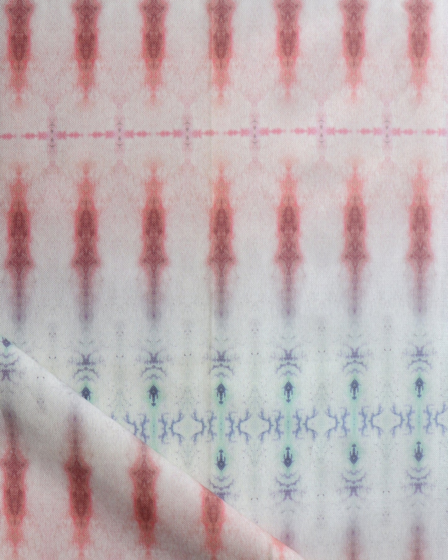 A close up of a vintage rug with an Akimbo 7 Fabric Color design, showcasing a graphic geometric pattern in pink and blue fabric