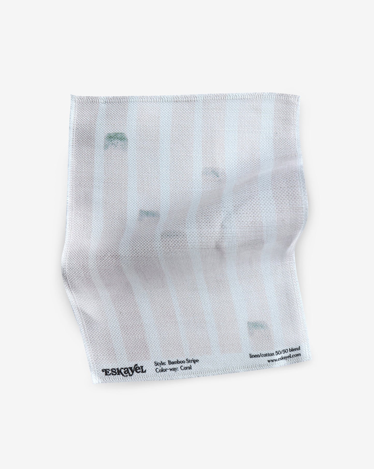 A white cloth with a green stripe from the Bamboo Stripe Fabric Coral range