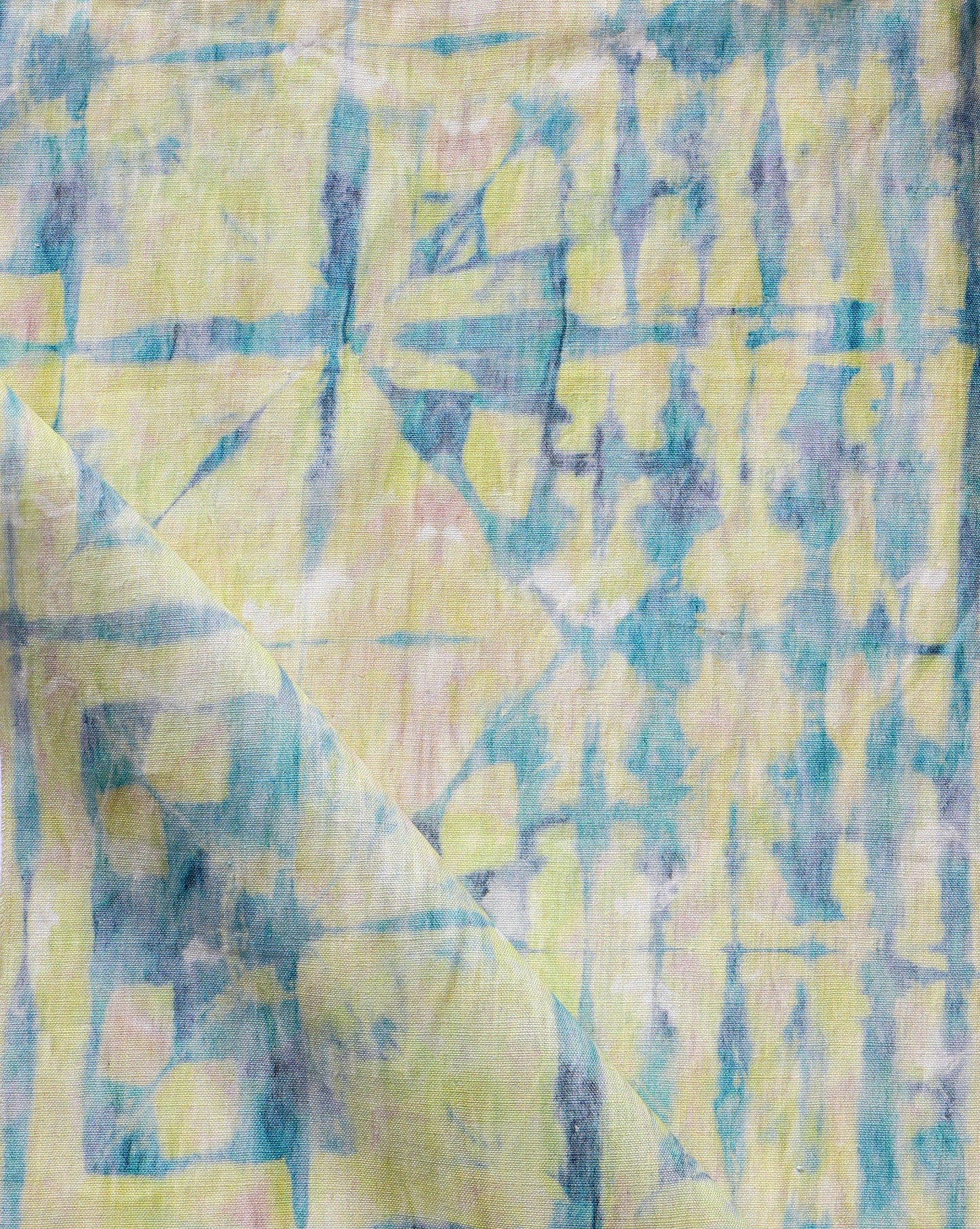A high-end Banda fabric featuring shibori tie-dye techniques creates a stunning blue and yellow design