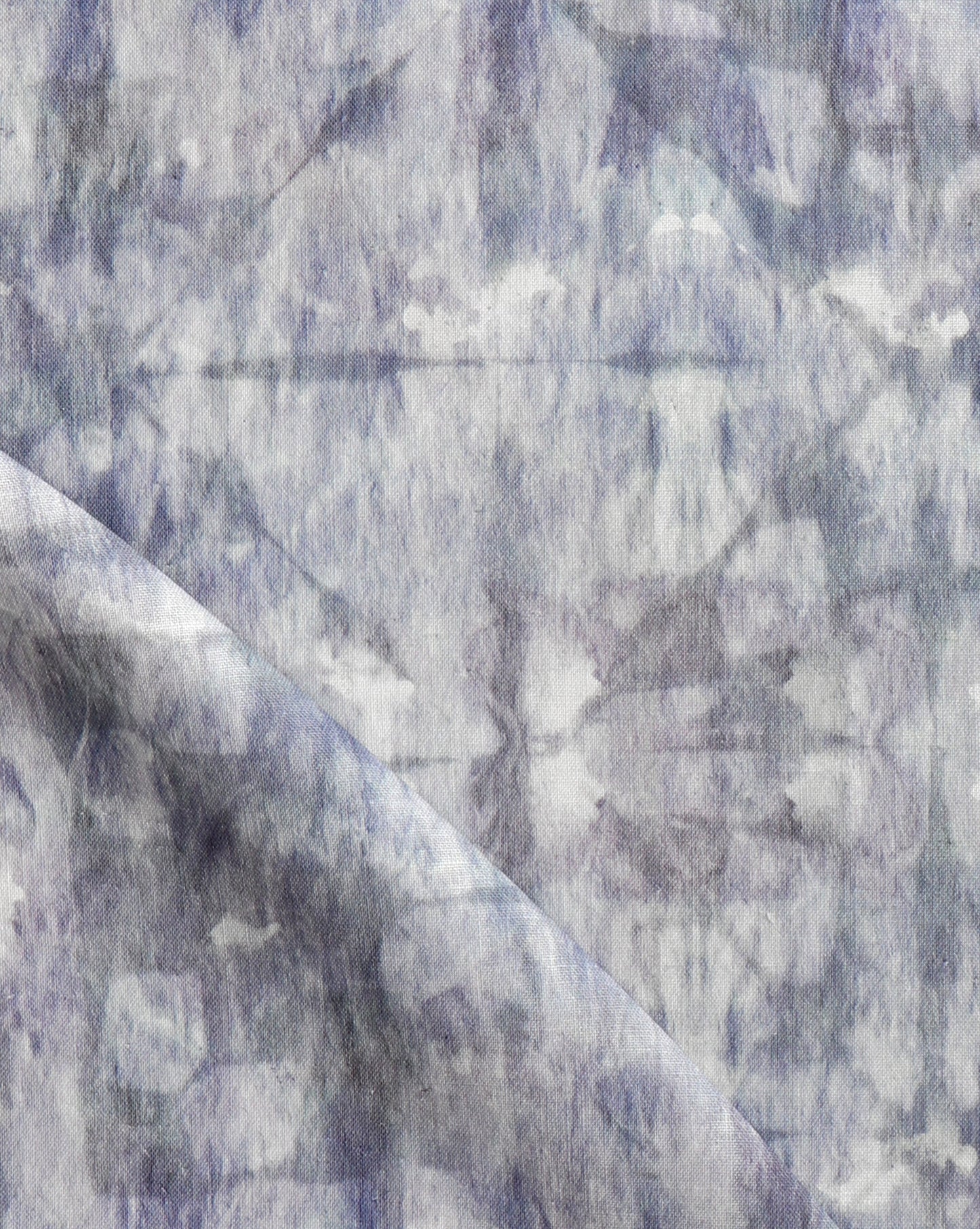 A close up image of a blue and white Banda Fabric Dove showcasing tie-dye techniques