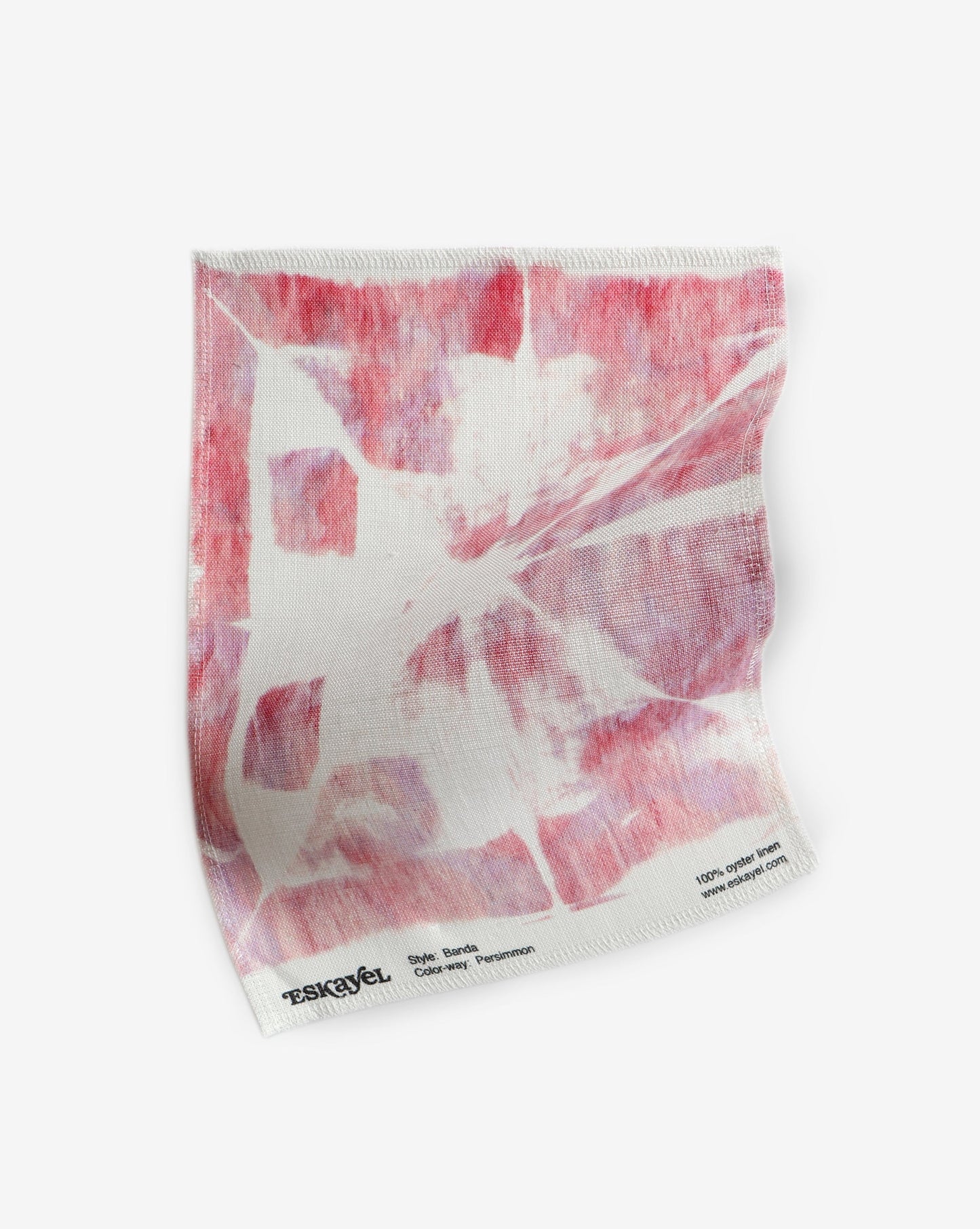 A luxury Banda Fabric Persimmon featuring a pink and white painting on a white background is created using tie-dye techniques
