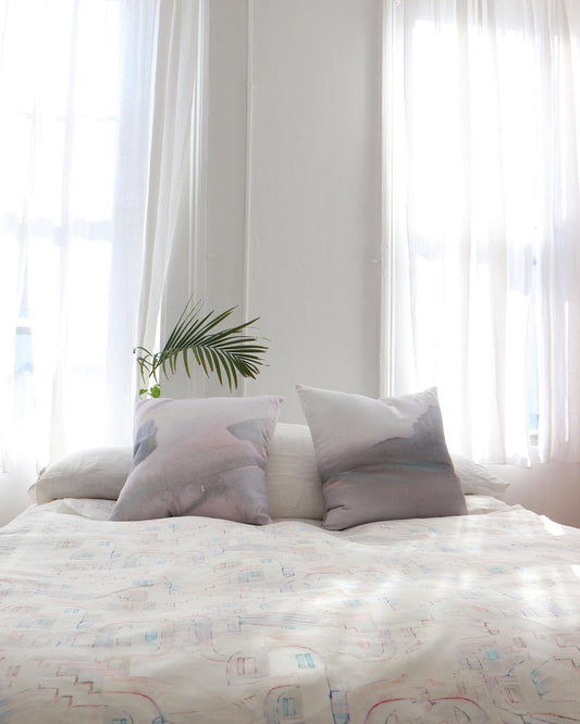 A bed with two pillows and a La Scala Fabric Multi on it