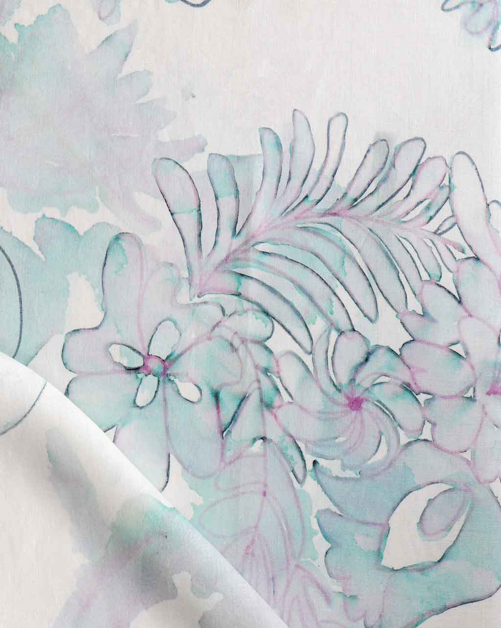 A close up of a Belize Blooms Fabric Jardin floral pattern on luxury wallpaper