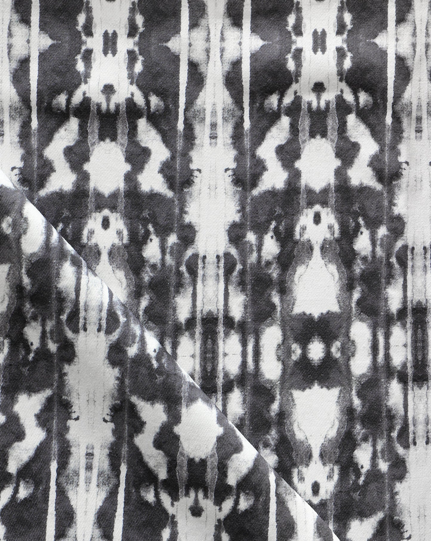 A close up of Biami Fabric Black, a high-end black and white tie dye fabric