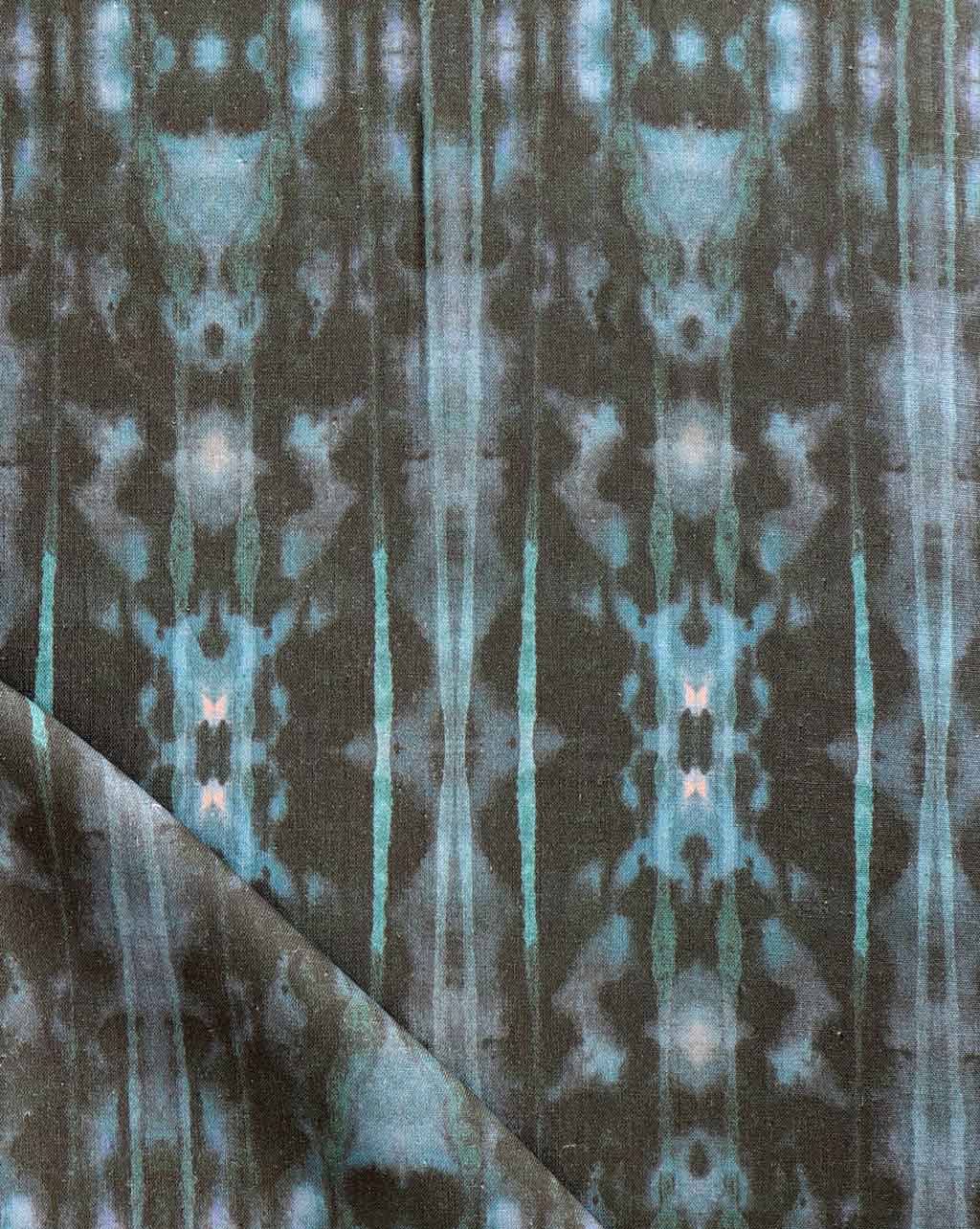A close up of a blue and green tie-dyed high-end Biami Fabric in the Waterstone pattern