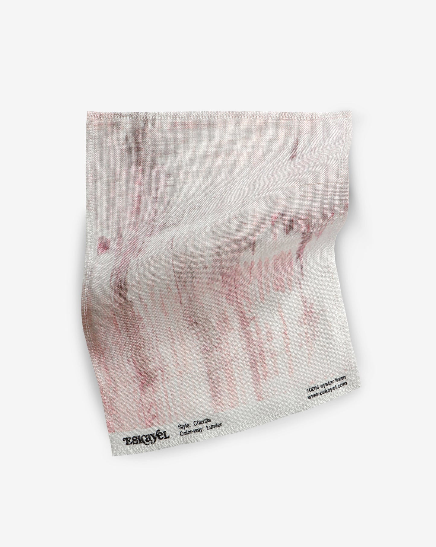 A Cherifia Fabric Sample with pink paint on it