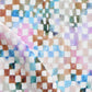 A close up of Chess Fabric Multi, a colorful checkered pattern