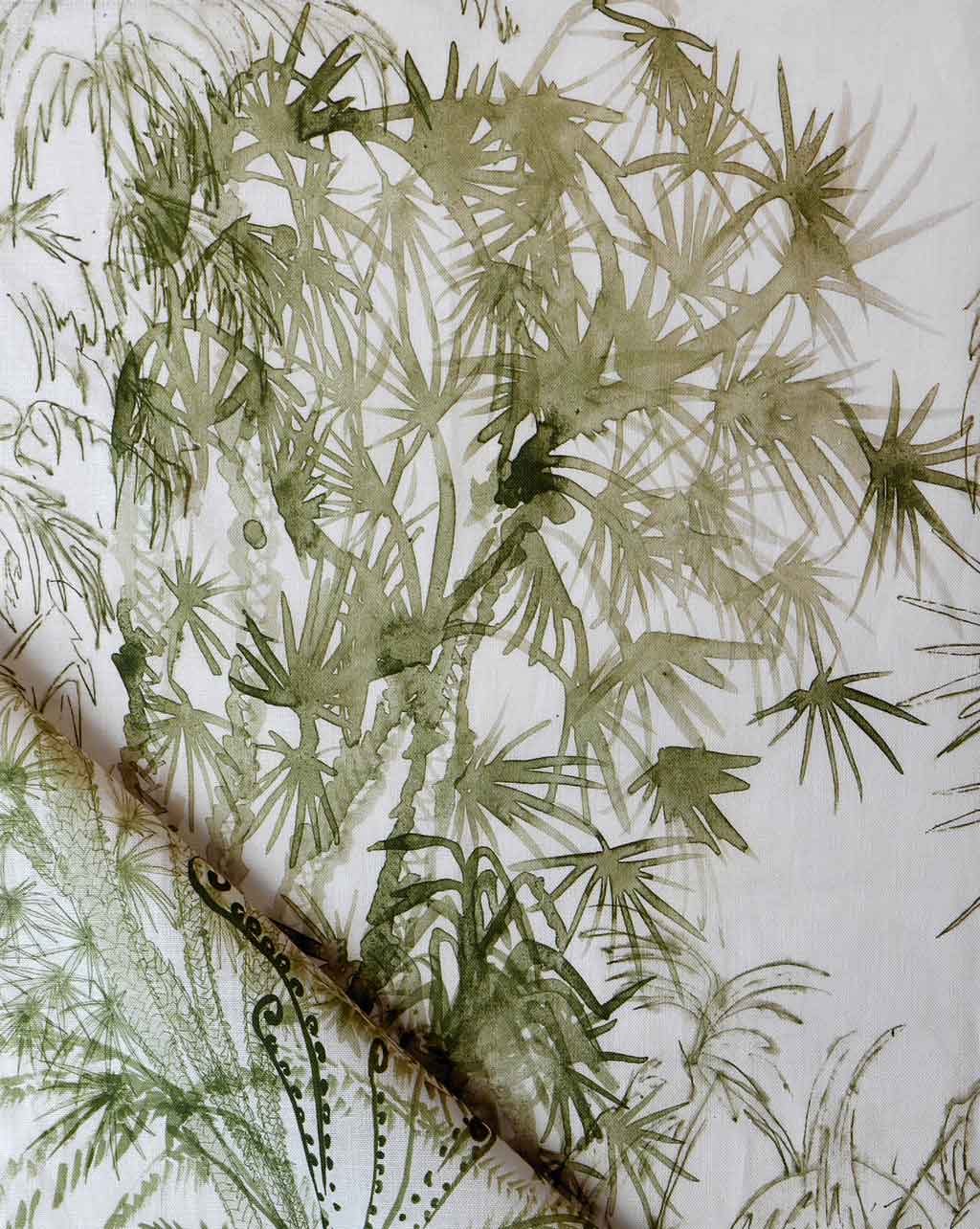 A close up of a piece of Domenica Fabric with green leaves on it