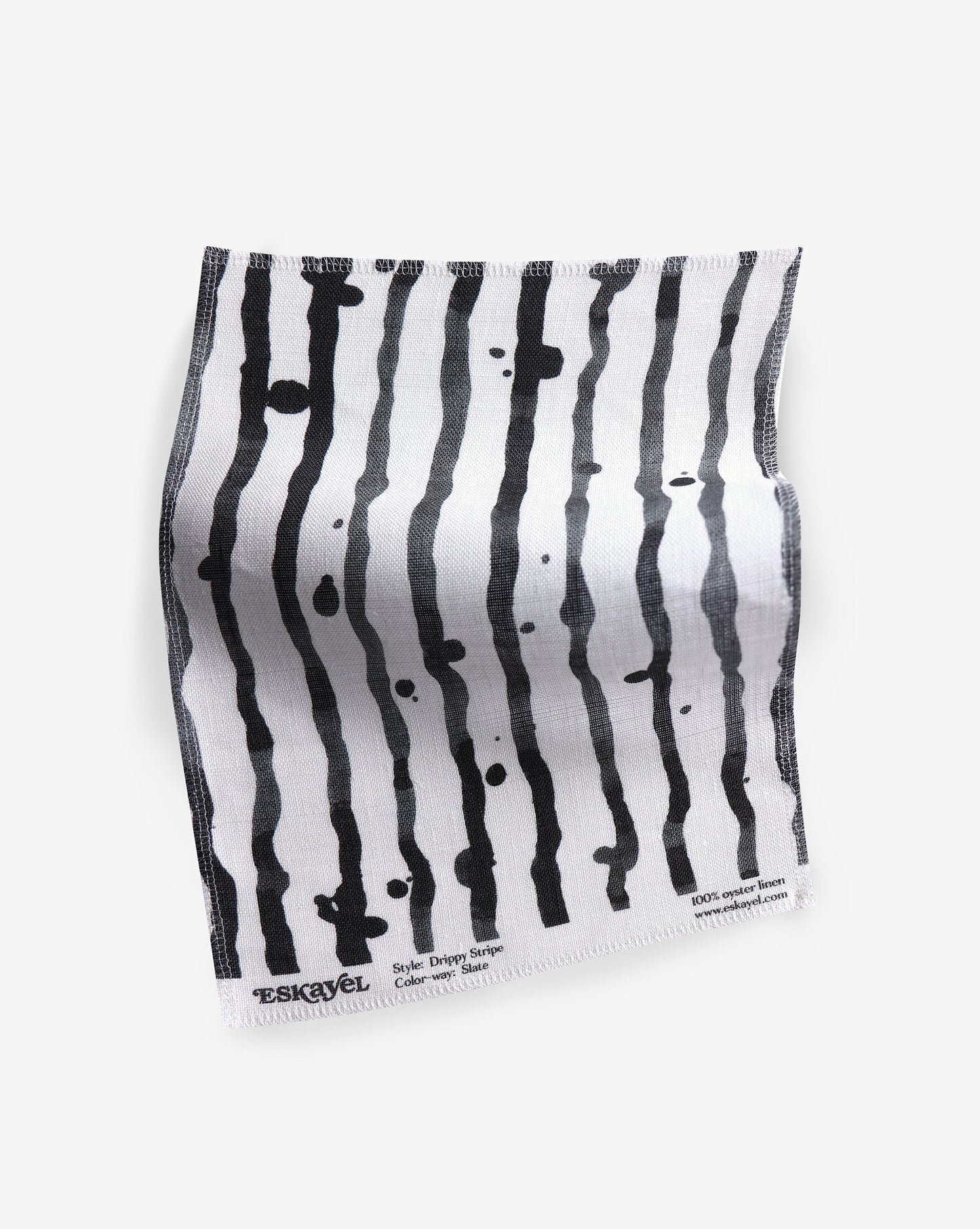 a Drippy Stripe Fabric Sample Slate with black and white stripes on it
